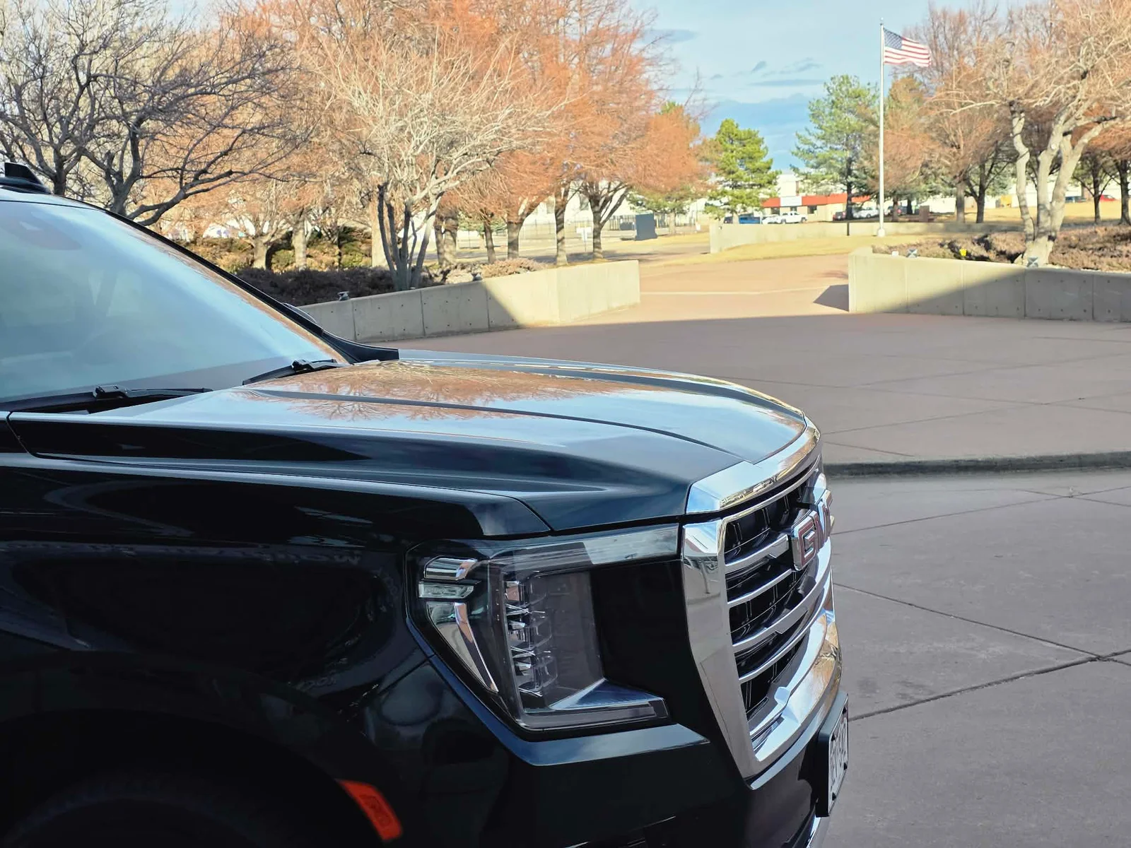 Detailed black GMC SUV in profile at a Colorado terminal on a clear day
